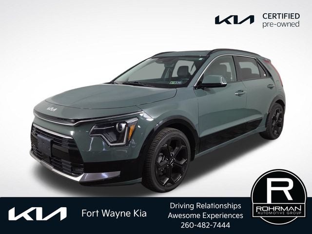 2023 Kia Niro EX Touring in Cityscape Green — front three-quarter view